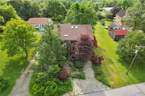 an aerial view of a house with yard swimming pool and outdoor seating