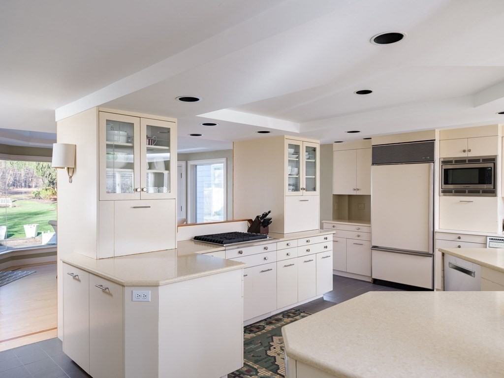 17 Cushing Street Hingham, MA 02043 - Photo 27 of 41 a kitchen with white cabinets and white appliances