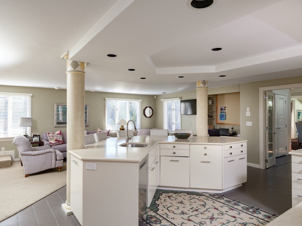 17 Cushing Street Hingham, MA 02043 - Photo 29 of 41 a large white kitchen with a sink and living room view