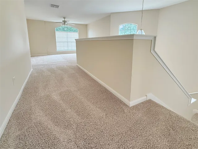 a view of a big room with windows