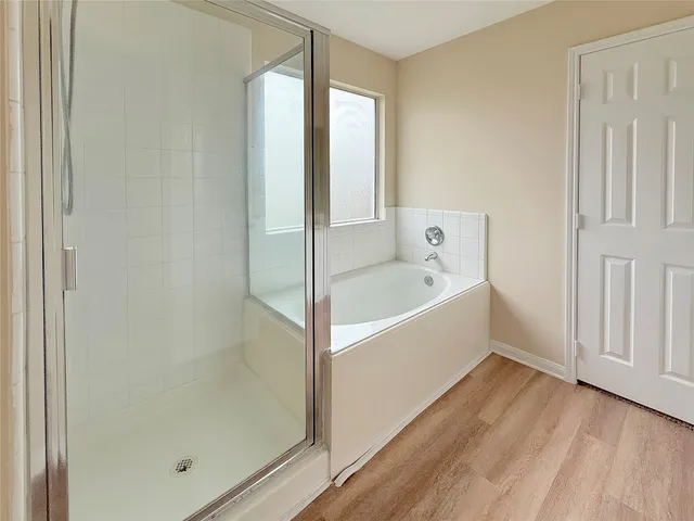 a bathroom with a bathtub and shower