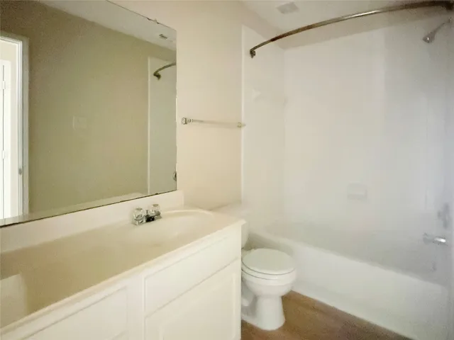 a bathroom with a shower and a toilet sink