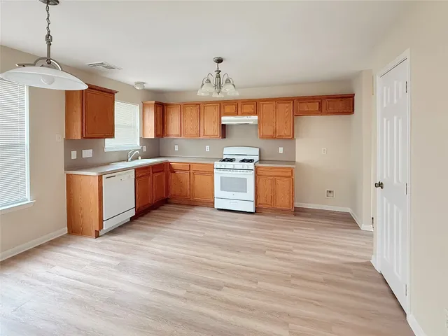 a kitchen with stainless steel appliances granite countertop a stove and a sink
