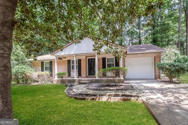 a front view of a house with a yard and porch