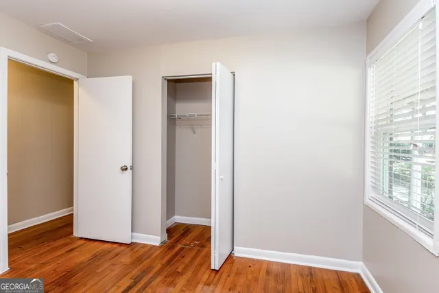 a view of room with window and wooden floor