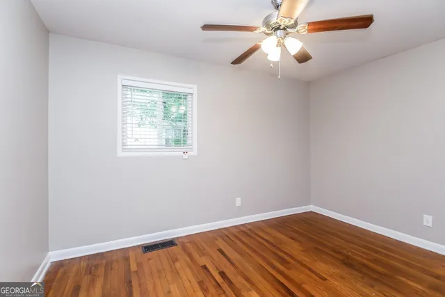 wooden floor in an empty room with a window