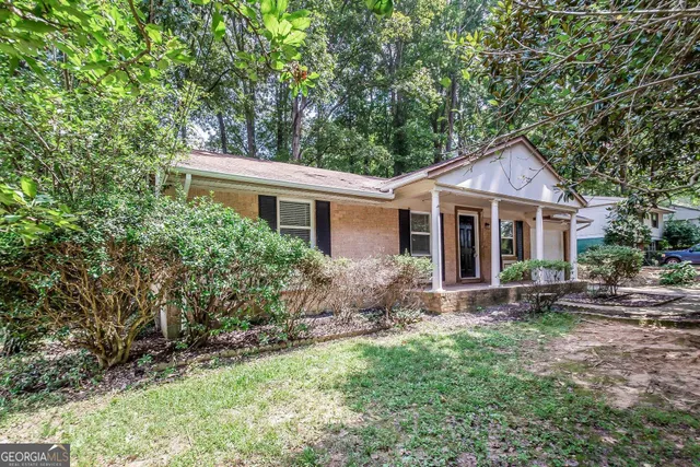 a front view of house with yard and green space
