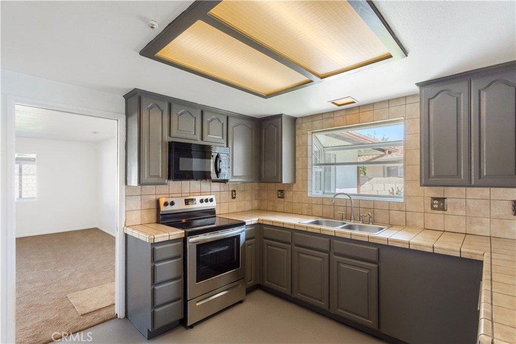 2348 Los Altos Circle Hemet, CA 92545 - Photo 11 of 35 a kitchen with a sink stove and microwave