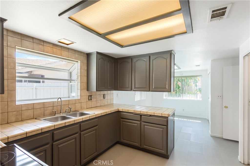 2348 Los Altos Circle Hemet, CA 92545 - Photo 13 of 35 a kitchen with a sink cabinets appliances and a window