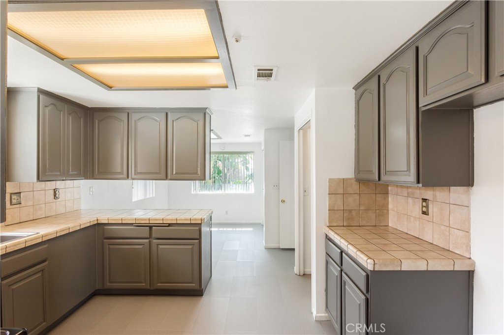 2348 Los Altos Circle Hemet, CA 92545 - Photo 14 of 35 a kitchen with a sink stove and cabinets