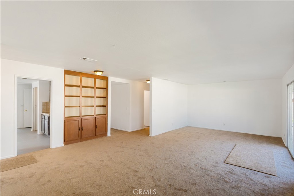 2348 Los Altos Circle Hemet, CA 92545 - Photo 16 of 35 an empty room with a window and a kitchen