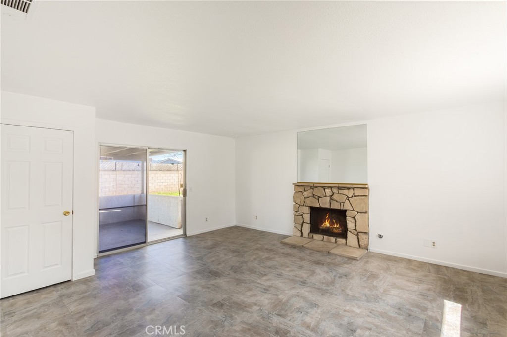 2348 Los Altos Circle Hemet, CA 92545 - Photo 19 of 35 an empty room with a fireplace and window