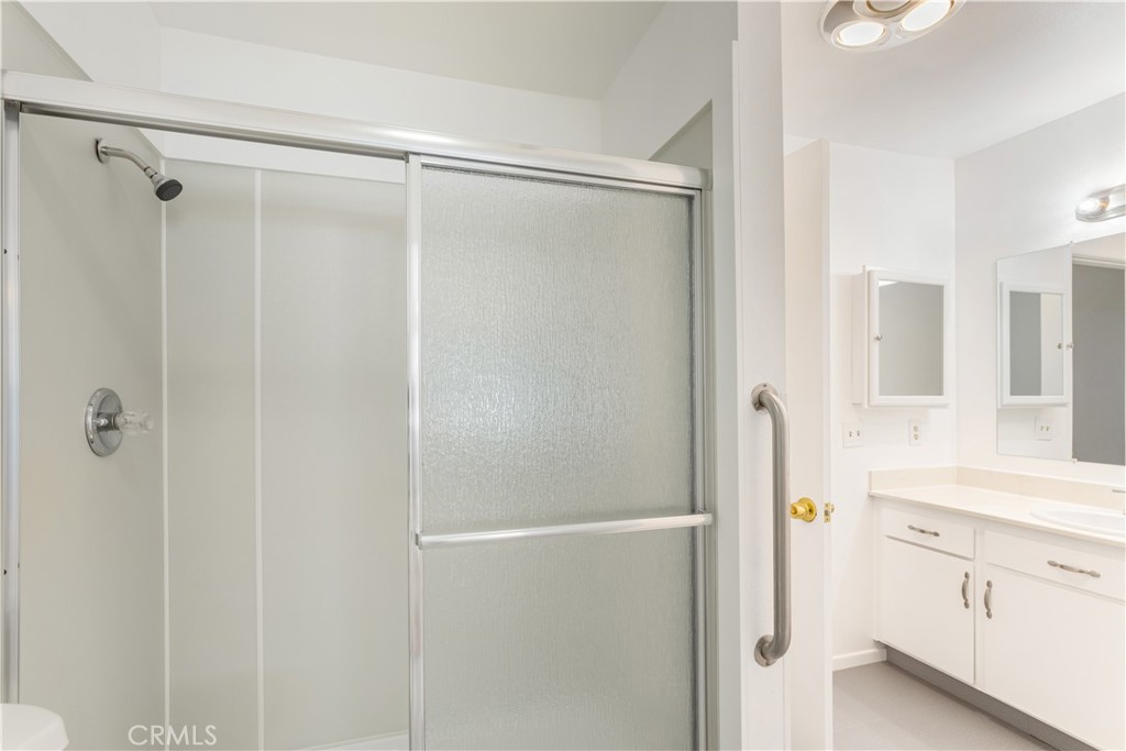 2348 Los Altos Circle Hemet, CA 92545 - Photo 30 of 35 a bathroom with a shower sink and mirror