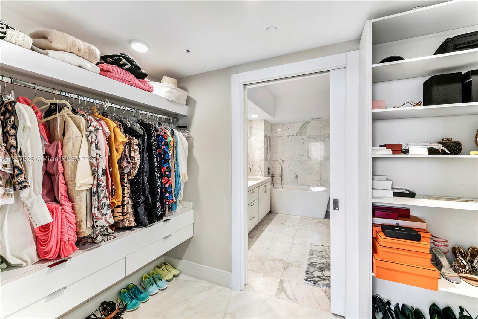 400 Alton Road, Unit 1405 Miami Beach, FL 33139 - Photo 13 of 18 a view of walk in closet with clothes and shoes