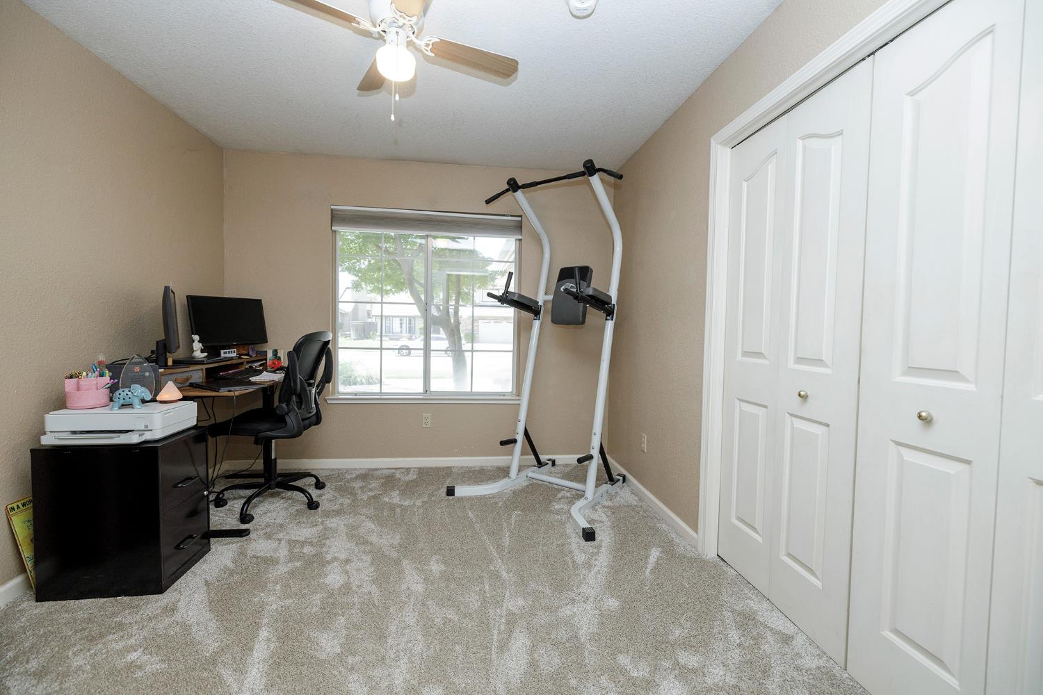 230 Meyenberg Avenue Ripon, CA 95366 - Photo 30 of 52 a view of a workspace with furniture and a window