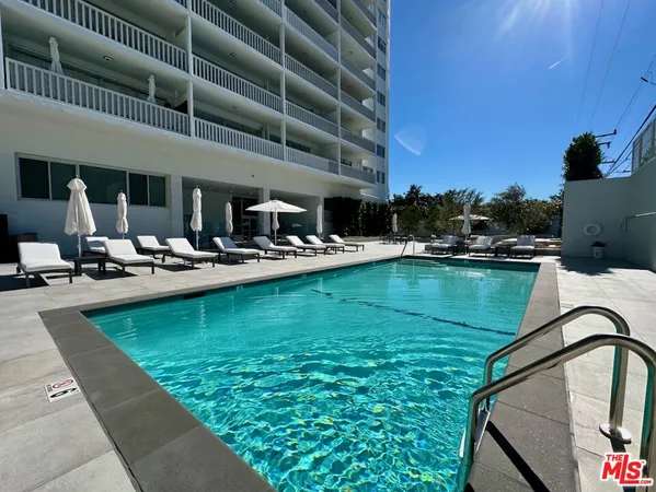 a view of a swimming pool with outdoor seating