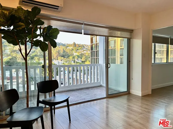 a view of a livingroom with furniture and a window