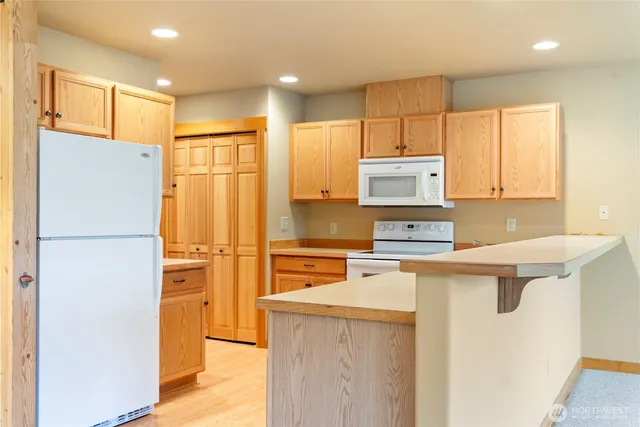 a kitchen with cabinets and window