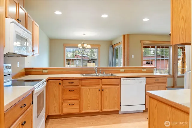 a kitchen with a cabinets and white appliances