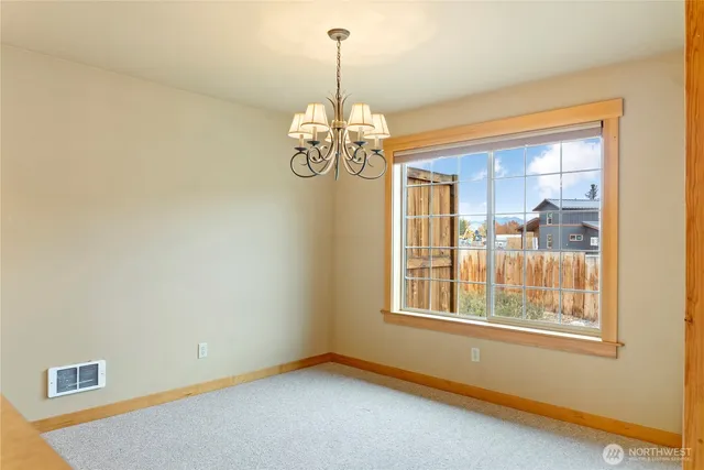 a view of a big room with chandelier windows and a chandelier