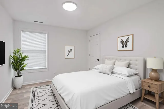 a bedroom with a bed and a couch