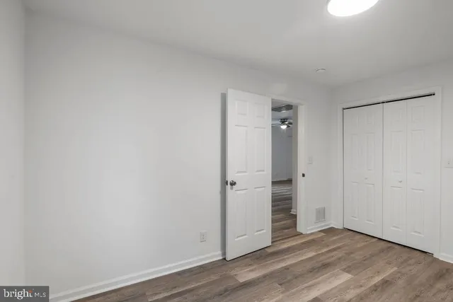 a view of an empty room and wooden floor