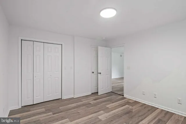 a view of an empty room and wooden floor