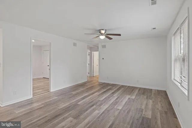 wooden floor in an empty room with a window
