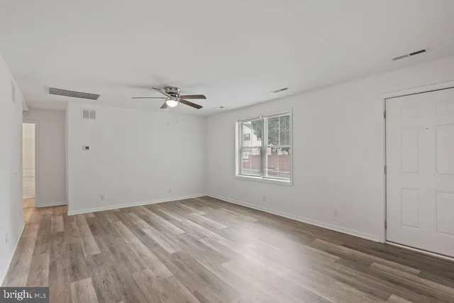 wooden floor in an empty room with a window