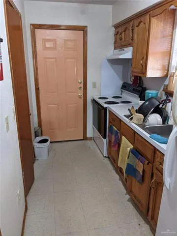 a kitchen with a stove and a refrigerator