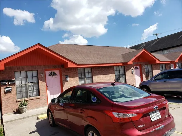 a front view of a house with parking space