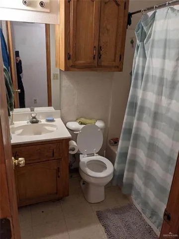 a bathroom with a sink toilet and mirror