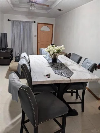 a dining room with furniture and wooden floor