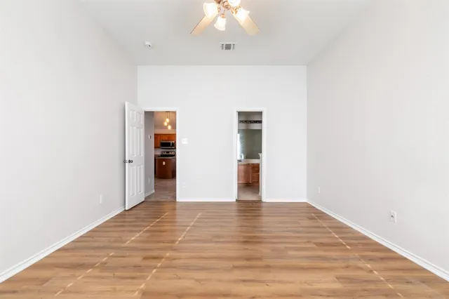 a view of an empty room with wooden floor
