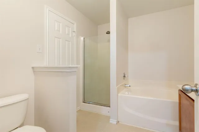 a bathroom with a bathtub and a toilet