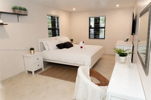 a large white bed in a white room