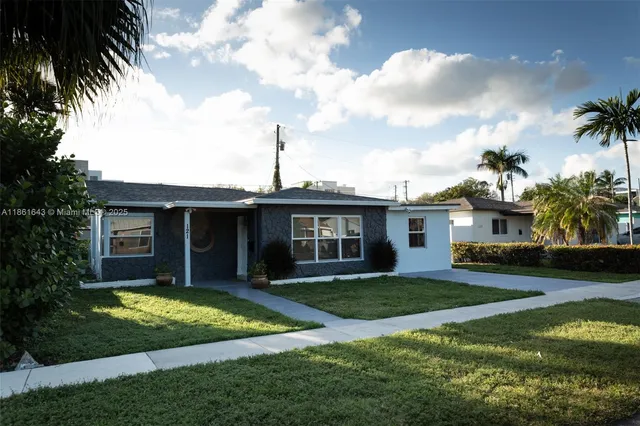 a view of a backyard with plants and a patio