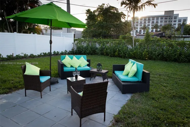 a front view of multi story residential apartment building with yard and green space