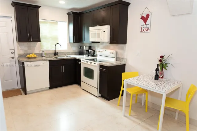 a kitchen with a stove a sink and a microwave