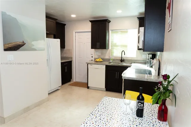 a kitchen with a sink appliances and cabinets