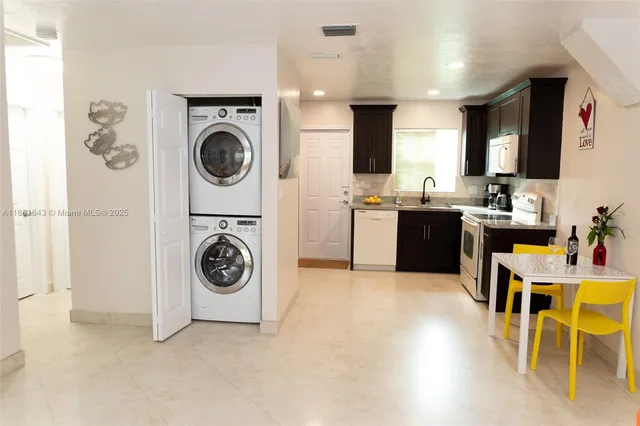 a view of a kitchen with sink washer and dryer