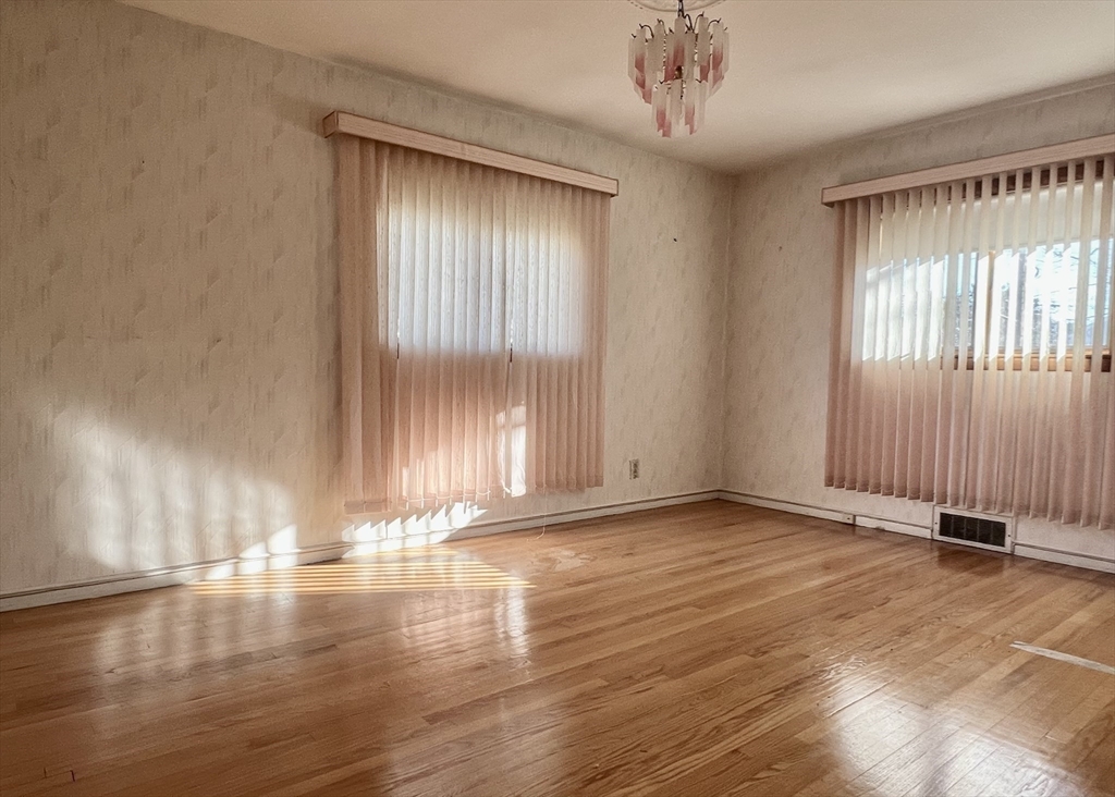 7 Ames Road Marblehead, MA 01945 - Photo 9 of 12 an empty room with wooden floor and windows