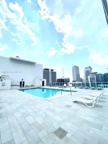a view of a backyard with a patio and a fire pit