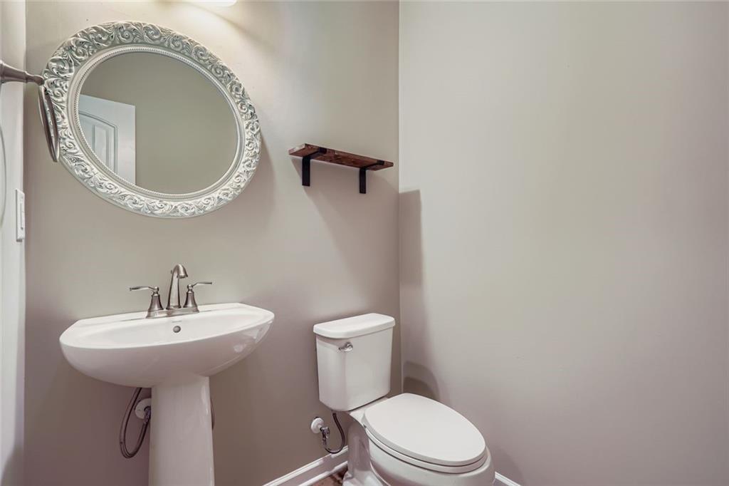 114 Greenbrier Way Canton, GA 30114 - Photo 13 of 32 a bathroom with a sink a toilet and a mirror
