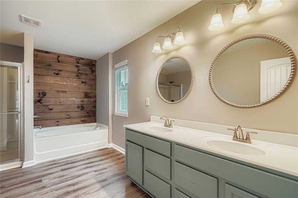 114 Greenbrier Way Canton, GA 30114 - Photo 15 of 32 a bathroom with a double vanity sink mirror and bathtub