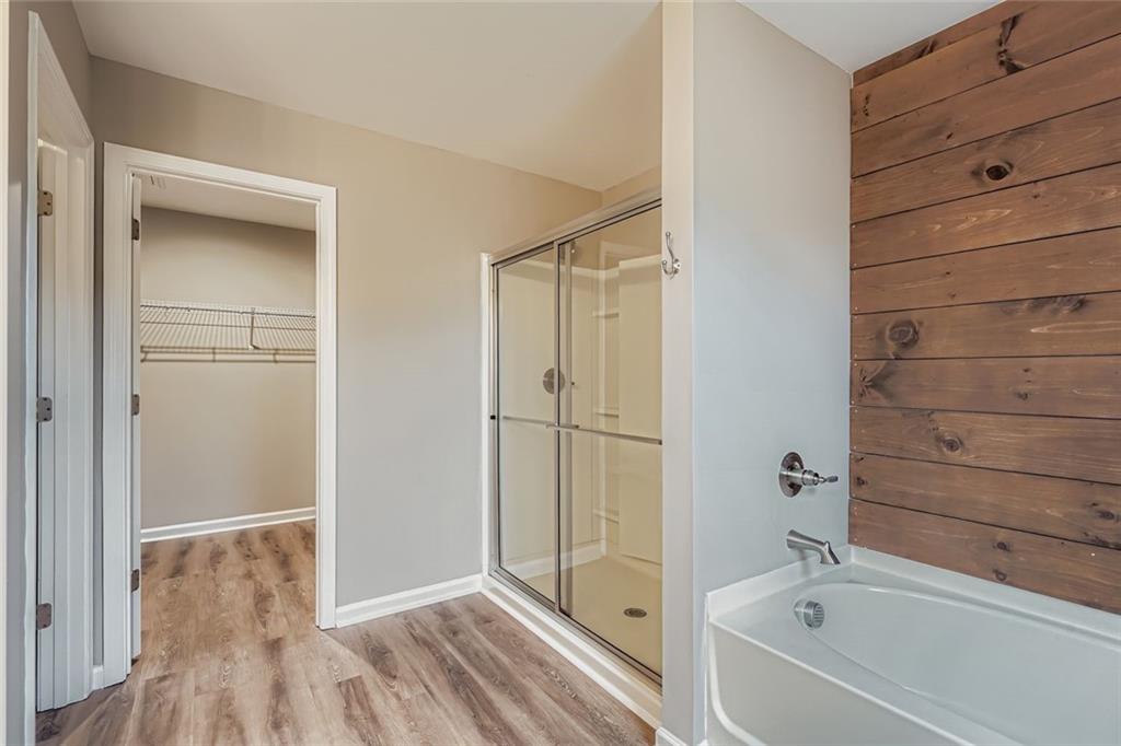 114 Greenbrier Way Canton, GA 30114 - Photo 16 of 32 a bathroom with a bathtub and shower