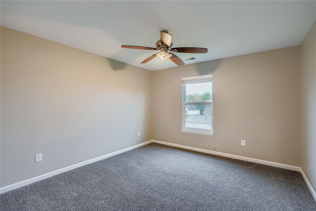 114 Greenbrier Way Canton, GA 30114 - Photo 17 of 32 an empty room with a window and a fan