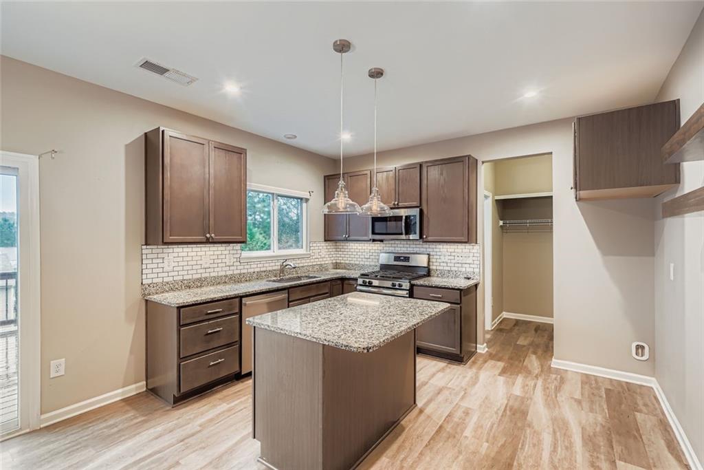 114 Greenbrier Way Canton, GA 30114 - Photo 2 of 32 a kitchen with a sink stove top oven and refrigerator
