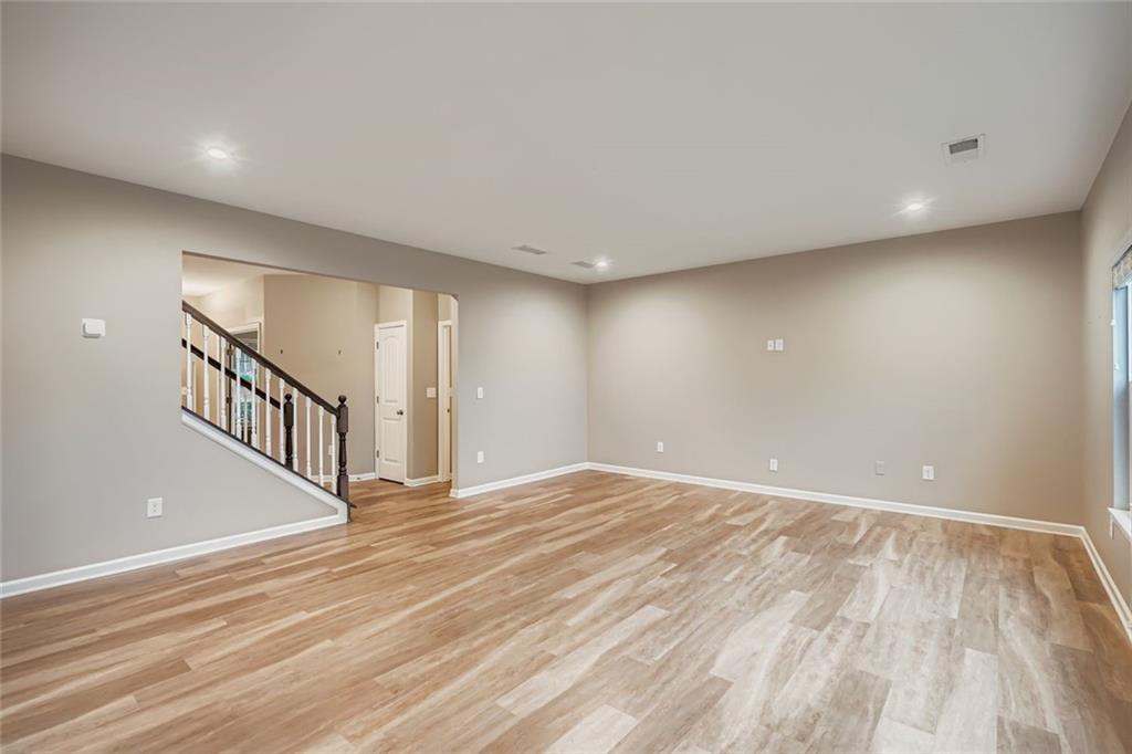 114 Greenbrier Way Canton, GA 30114 - Photo 4 of 32 a view of an empty room with wooden floor