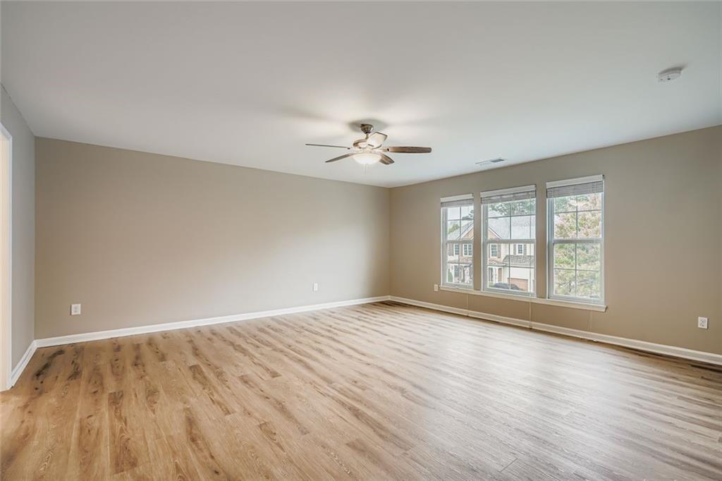 114 Greenbrier Way Canton, GA 30114 - Photo 5 of 32 wooden floor in an empty room with a window